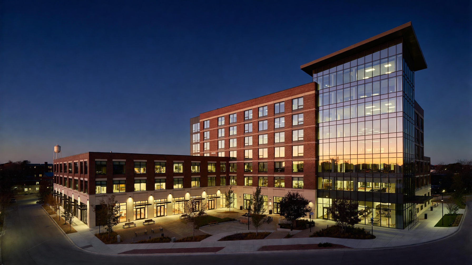 Brick and glass mixed-use development at twilight